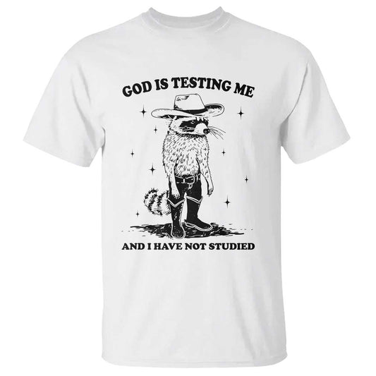 funny-god-is-testing-me-and-i-have-not-studied-t-shirt-cowboy-racoon